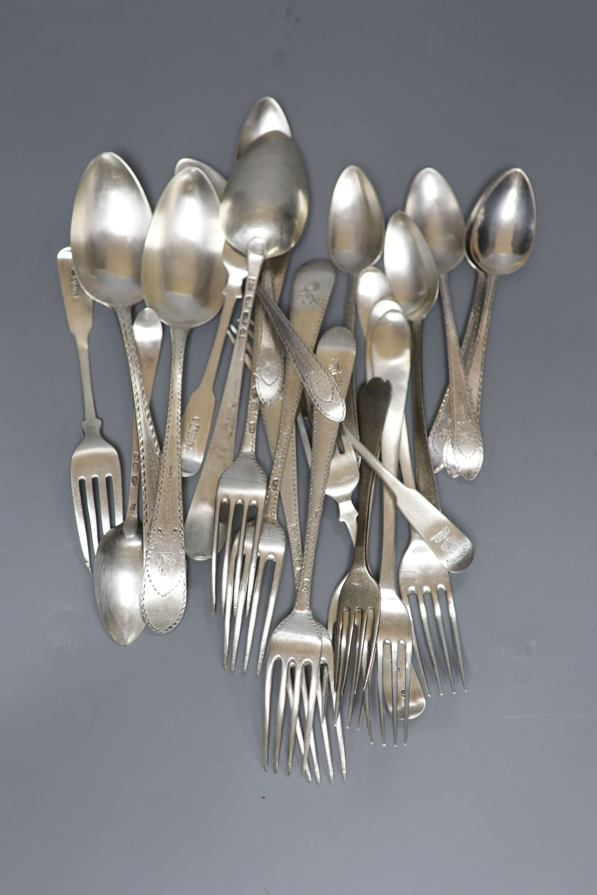 A set of eight George III Irish bright cut engraved Celtic tip spoons and three table spoons, Jon Power, Dublin, 1791/2, &12 forks.
